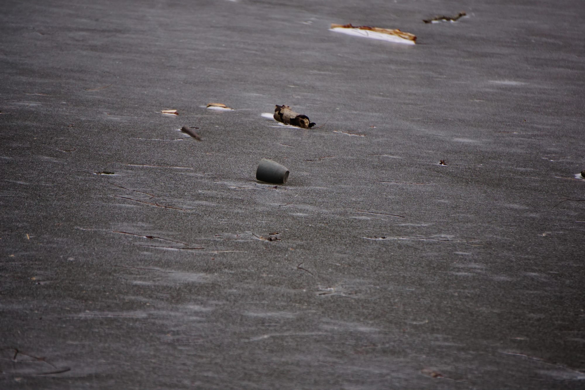 A coffee mug, abandoned in the middle of a frozen lake