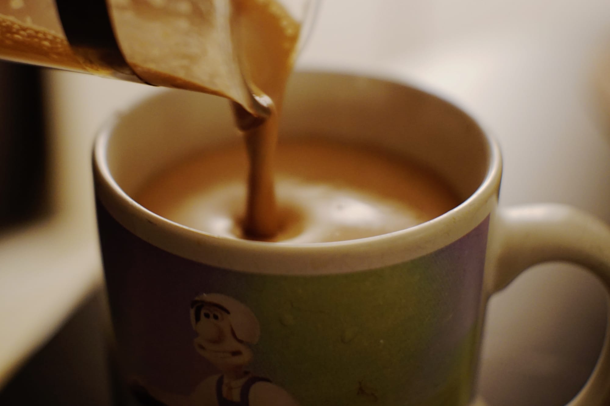 Foamed hot chocolate being poured into a wallace and gromit mug